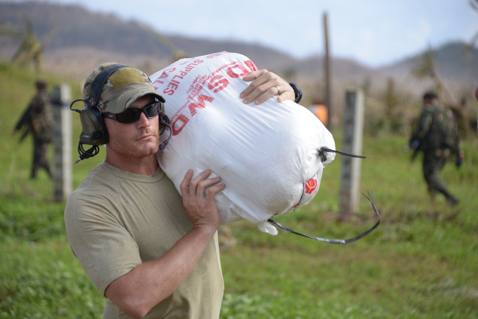 Tech. Sgt. Joshua Brown offloads supplies Nov. 17, 2013, at Guiuan Airport, Republic of the Philippines. A team from the 353rd Special Operation Group from Kadena Air Base, Japan, opened Guiuan Airport in the aftermath of Typhoon Haiyan, allowing for the delivery of food and supplies along with the transport of more than 1,000 people daily. Brown is a 353rd SOG pararescueman (U.S. Air Force photo by Tech. Sgt. Kristine Dreyer) 
