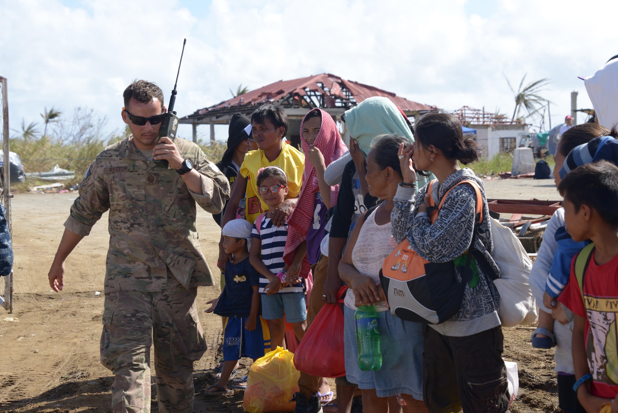 Master Sgt. Jeremy Rector works to coordinate airlift Nov. 17, 2013, at Guiuan Airport, Republic of the Philippines. Rector is deployed from Kadena Air Base, Japan, in support of Operation Damayan to help transport Philippine citizens and ensure the delivery of food and supplies to those affected by Typhoon Haiyan. Rector is a Deployed Aircraft Ground Response Element team member assigned to the 353rd Special Operations Support Squadron (U.S. Air Force photo by Tech. Sgt. Kristine Dreyer) 