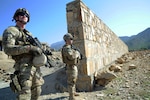 Spc. Andrew Simmons, and Army Sgt. Adam Priebe, both assigned to Company A, 1st Battalion, 143rd Infantry Regiment (Airborne), provide security outside the Shigal Girl's School in Kunar Province, Afghanistan while members of Provincial Reconstruction Team Kunar visit the school to check on the status of construction. The members of Company A serve as the PRT's security element and have earned high praise from the PRT commander.