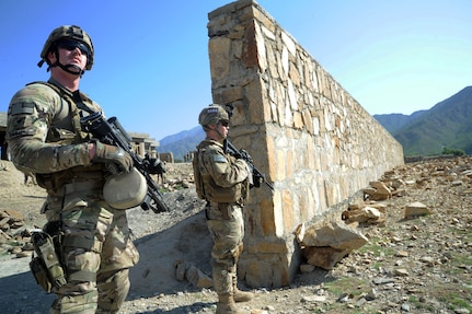 Spc. Andrew Simmons, and Army Sgt. Adam Priebe, both assigned to Company A, 1st Battalion, 143rd Infantry Regiment (Airborne), provide security outside the Shigal Girl's School in Kunar Province, Afghanistan while members of Provincial Reconstruction Team Kunar visit the school to check on the status of construction. The members of Company A serve as the PRT's security element and have earned high praise from the PRT commander.