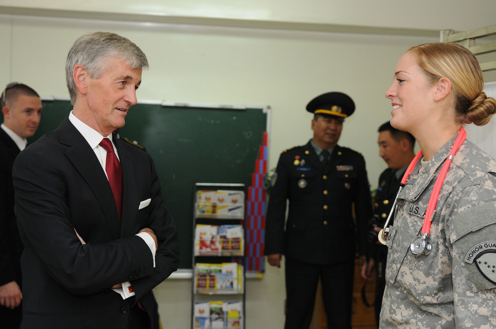 Secretary of the Army John M. McHugh talks with Army Pfc. Chantal Miller, a medic with the Alaska Army National Guard's Medical Detachment, during his visit of the various Khaan Quest 12 exercise locations in and around Ulaanbaatar, Mongolia, Aug. 14. Khaan Quest is a regularly scheduled, multinational exercise sponsored by the U.S. Army, Pacific and hosted annually by the Mongolian Armed Forces.