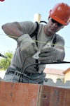 Airman 1st Class Jeremiah Voyles, with the Wyoming Air National Guard's 153rd Civil Engineer Squadron, prepares to put rebar in place Aug. 13, 2012 while working on a construction project at the NATO School in Oberammergau, Germany. The rebar provides strength to the concrete poured. Airmen from the 153rd CES are putting their skills to work as they work on various construction projects throughout the school grounds.