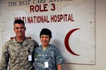 Army Maj. Elizabeth Nance, a dental officer with the Virginia Army National Guard currently assigned to the ROLE 3 hospital at Kandahar Airfield, Afghanistan, stands with her son, Marine Corps Capt. Wilson Nance.