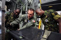 Air Force Master Sgt. Chris Choate, with the North Carolina Air National Guard's 156th Aeromedical Evacuation Squadron, shows members of the Botswana Defense Force how to properly secure a litter on a BDF C-130 Hercules aircraft as part of training exercise MEDLITE 12, Aug. 11, 2012. MEDLITE is an annual exercise that brings together U.S. forces personnel with counterparts from militaries throughout Africa. The goal of the exercise is to enhance capabilities and work together by introducing the U.S. Aeromedical Evacuation system of patient movement to the BDF military personnel.