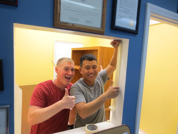 (left to right)Cpl Braastad and Cpl Her from 3/6, 6th Marine Regiment, 2nd Marine Division help re-paint the rooms at the Onlsow Community Outreach Center.