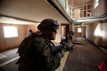 Marines with Transportation and Support Company, Combat Logistics Battalion 2, 2nd Marine Logistics Group clear rooms during a fire team challenge at the Lejeune Military Operations on Urbanized Terrain (MOUT) town aboard Camp Lejeune, N.C., Nov. 20, 2013. Service members had to perform challenges at seven different stations and show proficiency in skills outside of their individual military occupational specialties. (U.S. Marine Corps photo by Lance Cpl. Shawn Valosin)