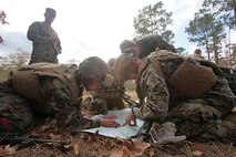 Marines with Transportation and Support Company, Combat Logistics Battalion 2, 2nd Marine Logistics Group demonstrate proficiency with map reading during a fire team challenge at the Lejeune Military Operations on Urbanized Terrain (MOUT) town aboard Camp Lejeune, N.C., Nov. 20, 2013. The winning team received a 72-hour liberty period and a meritorious mast and certificate of commendation from the company commanding officer for the winning squad leader. (U.S. Marine Corps photo by Lance Cpl. Shawn Valosin)