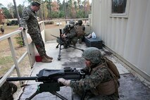 Marines with Transportation and Support Company, Combat Logistics Battalion 2, 2nd Marine Logistics Group are evaluated on disassembly and reassembly of crew-served weapons during a fire team challenge at the Lejeune Military Operations on Urbanized Terrain (MOUT) town aboard Camp Lejeune, N.C., Nov. 20, 2013. The challenge was used to ensure that Marines with the company are combat ready and to build trust and camaraderie. (U.S. Marine Corps photo by Lance Cpl. Shawn Valosin)