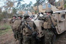 Marines with Transportation and Support Company, Combat Logistics Battalion 2, 2nd Marine Logistics Group rig a Humvee for a helicopter support team during a fire team challenge at the Lejeune Military Operations on Urbanized Terrain (MOUT) town aboard Camp Lejeune, N.C., Nov. 20, 2013. Service members had to perform challenges at seven different stations and show proficiency in skills outside of their individual military occupational specialties. (U.S. Marine Corps photo by Lance Cpl. Shawn Valosin)