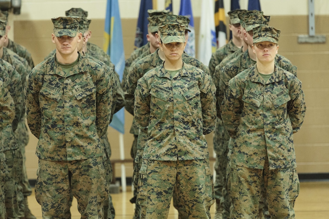 Pfc. Cristina Fuentes Montenegro, 25, one of the first three female Marine graduates from the School of Infantry-East’s Infantry Training Battalion course, and native of Coral Springs, Fla., left, and Pfc. Julia Carroll, 18, one of the first three female Marine graduates from the School of Infantry-East’s Infantry Training Battalion course, and native of Idaho Falls, Idaho, stand at the position of parade rest during the graduation of Delta Company, Infantry Training Battalion, School of Infantry-East at Camp Geiger, N.C. Nov. 21. The graduation of 227 students marked the first class of Marines to include females. The class was part of the Marine Corps’ research effort toward integrating women into ground-combat military occupational specialties. (Official U.S. Marine Corps photo by Lance Cpl. Justin A. Rodriguez/Released)