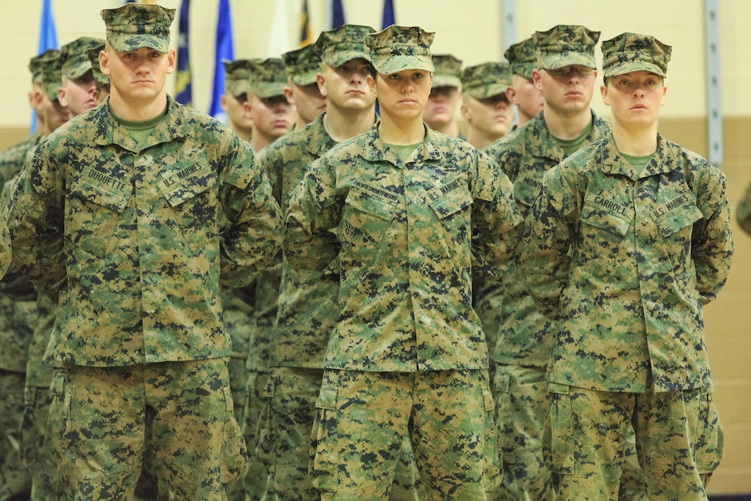 Pfc. Cristina Fuentes Montenegro, 25, one of the first three female Marine graduates from the School of Infantry-East’s Infantry Training Battalion course, and native of Coral Springs, Fla., left, and Pfc. Julia Carroll, 18, one of the first three female Marine graduates from the School of Infantry-East’s Infantry Training Battalion course, and native of Idaho Falls, Idaho, stand at the position of parade rest during the graduation of Delta Company, Infantry Training Battalion, School of Infantry-East at Camp Geiger, N.C. Nov. 21. The graduation of 224 students marked the first class of Marines to include females. The class was part of the Marine Corps’ research effort toward integrating women into ground-combat military occupational specialties. (Official U.S. Marine Corps photo by Lance Cpl. Justin A. Rodriguez/Released)