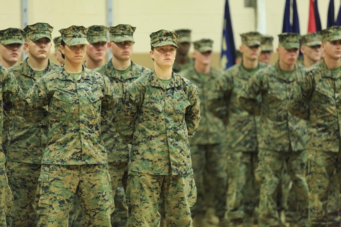 Pfc. Cristina Fuentes Montenegro, 25, one of the first three female Marine graduates from the School of Infantry-East’s Infantry Training Battalion course, and native of Coral Springs, Fla., left, and Pfc. Julia Carroll, 18, one of the first three female Marine graduates from the School of Infantry-East’s Infantry Training Battalion course, and native of Idaho Falls, Idaho, stand at the position of parade rest during the graduation of Delta Company, Infantry Training Battalion, School of Infantry-East at Camp Geiger, N.C. Nov. 21. The graduation of 224 students marked the first class of Marines to include females. The class was part of the Marine Corps’ research effort toward integrating women into ground-combat military occupational specialties. (Official U.S. Marine Corps photo by Lance Cpl. Justin A. Rodriguez/Released)