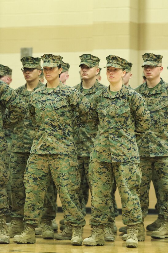 Pfc. Cristina Fuentes Montenegro, 25, one of the first three female Marine graduates from the School of Infantry-East’s Infantry Training Battalion course, and native of Coral Springs, Fla., left, and Pfc. Julia Carroll, 18, one of the first three female Marine graduates from the School of Infantry-East’s Infantry Training Battalion course, and native of Idaho Falls, Idaho, stand at the position of parade rest during the graduation of Delta Company, Infantry Training Battalion, School of Infantry-East at Camp Geiger, N.C. Nov. 21. The graduation of 227students marked the first class of Marines to include females. The class was part of the Marine Corps’ research effort toward integrating women into ground-combat military occupational specialties. (Official U.S. Marine Corps photo by Lance Cpl. Justin A. Rodriguez/Released)