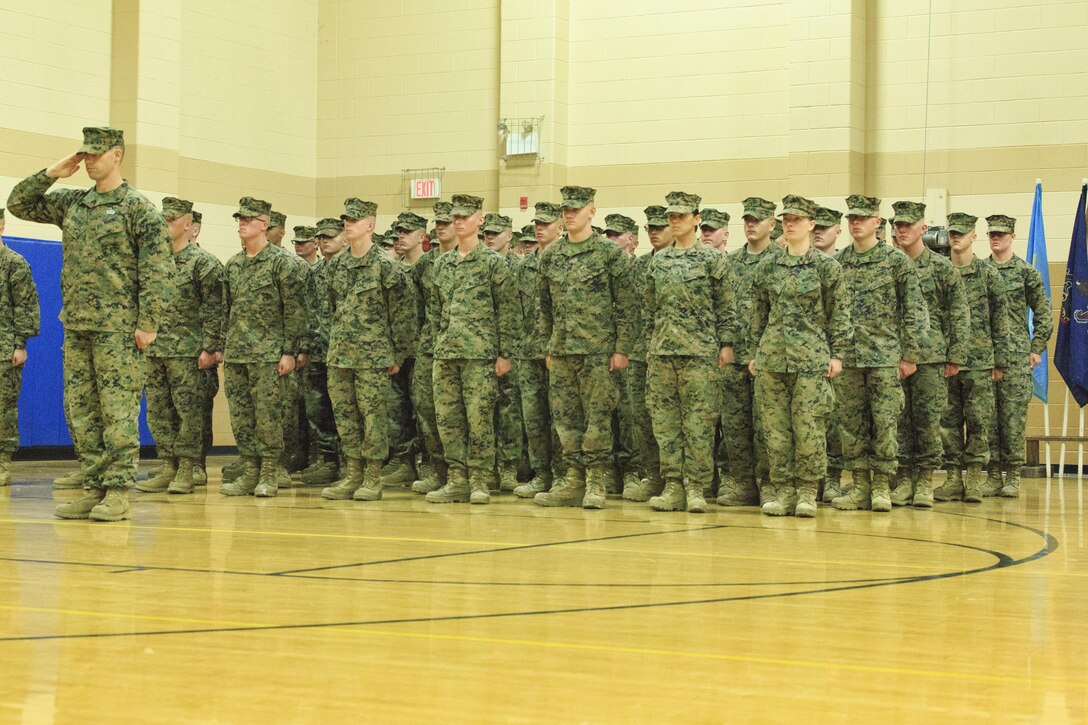 Students and staff of Delta Company, Infantry Training Battalion, School of Infantry-East stand at attention during the graduation ceremony at Camp Geiger, N.C. Nov. 21. The graduation of 227 students marked the first class of Marines to include females. The class was part of the Marine Corps’ research effort toward integrating women into ground-combat military occupational specialties. (Official U.S. Marine Corps photo by Lance Cpl. Justin A. Rodriguez/Released)