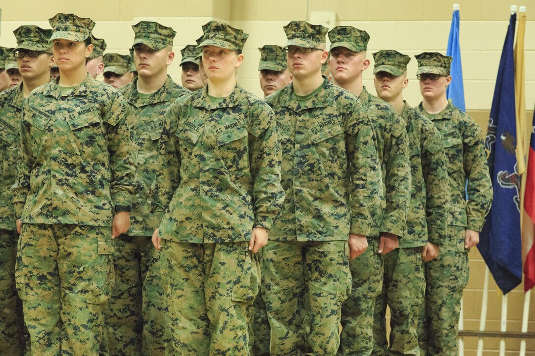 Pfc. Cristina Fuentes Montenegro, 25, one of the first three female Marine graduates from the School of Infantry-East’s Infantry Training Battalion course, and native of Coral Springs, Fla., left, and Pfc. Julia Carroll, 18, one of the first three female Marine graduates from the School of Infantry-East’s Infantry Training Battalion course, and native of Idaho Falls, Idaho, stand at the position of attention during the graduation of Delta Company, Infantry Training Battalion, School of Infantry-East at Camp Geiger, N.C. Nov. 21. The graduation of 227 students marked the first class of Marines to include females. The class was part of the Marine Corps’ research effort toward integrating women into ground-combat military occupational specialties. (Official U.S. Marine Corps photo by Lance Cpl. Justin A. Rodriguez/Released)