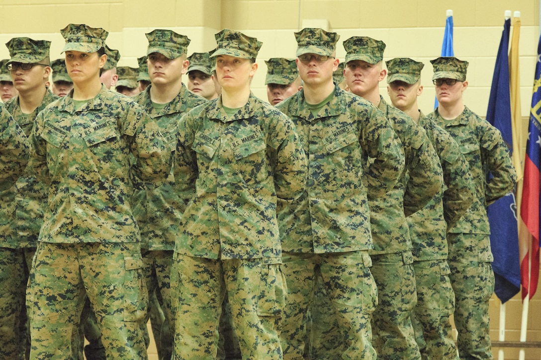 Pfc. Cristina Fuentes Montenegro, 25, one of the first three female Marine graduates from the School of Infantry-East’s Infantry Training Battalion course, and native of Coral Springs, Fla., left, and Pfc. Julia Carroll, 18, one of the first three female Marine graduates from the School of Infantry-East’s Infantry Training Battalion course, and native of Idaho Falls, Idaho, stand at the position of parade rest during the graduation of Delta Company, Infantry Training Battalion, School of Infantry-East at Camp Geiger, N.C. Nov. 21. The graduation of 227 students marked the first class of Marines to include females. The class was part of the Marine Corps’ research effort toward integrating women into ground-combat military occupational specialties. (Official U.S. Marine Corps photo by Lance Cpl. Justin A. Rodriguez/Released)