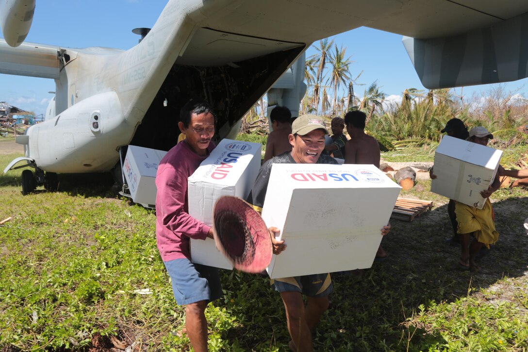 Philippine citizens offload relief supplies from a MV-22B Osprey during Operation Damayan,  Homonhon, Republic of The Philippines, Nov. 18. The 3rd Marine Expeditionary Brigade is assisting the Philippine government's ongoing relief efforts in response to the aftermath Typhoon Haiyan. (U.S. Marine Corps photo by Lance Cpl. Caleb Hoover/Released) 
