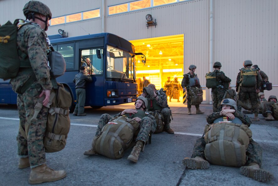 Marines with the 3rd Reconnaissance Battalion, 3rd Marine Division, III Marine Expeditionary Force, wait to board a C-130 Hercules at Yokota Air Base, Japan, Nov. 21, 2013. The training not only allowed the marines to practice jumping, but it also allowed the Yokota aircrews to practice flight tactics and timed-package drops. (U.S. Air Force photo by Osakabe Yasuo/Released)