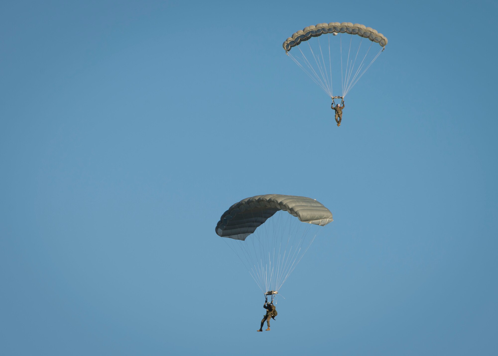 A Marine with the 3rd Marine Division, 3rd Reconnaissance Battalion, parachutes to the ground after jumping from a C-130 Hercules over Yokota Air Base, Japan, Nov. 19, 2013. The Marines perform these jumps quarterly to maintain the necessary qualifications. (U.S. Air Force photo by Staff Sgt. Chad C. Strohmeyer/Released)