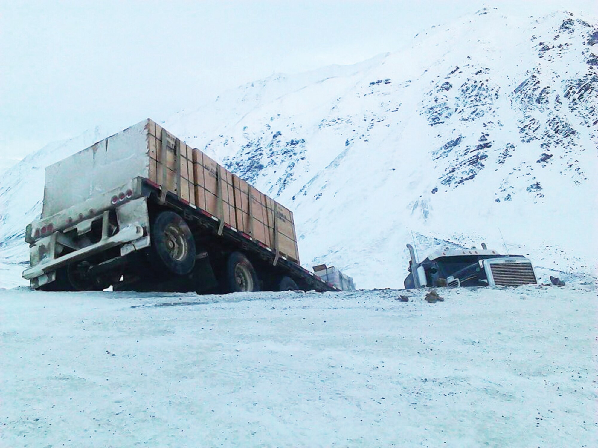 A tractor-trailer jackknifed on the Dalton Highway at Atigun Pass, Alaska, Nov. 2. In the vehicle behind the truck, two Air Force master sergeants were going hunting. They stopped and extracted the driver, who was perilously close to a 600-foot drop. (Courtesy photo)