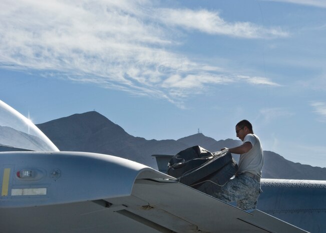 U.S. Air Force Staff Sgt. Jose Grijalva, 757th Aircraft Maintenance Squadron aerospace propulsion technician, removes engine covers from an A-10 Thunderbolt II Nov. 18, 2013, at Nellis Air Force Base, Nev. According to the A-10 factsheet, the aircraft can loiter near battle areas for extended periods of time and can operate in low ceiling and low visibility conditions.  (U.S. Air Force photo by Airman 1st Class Jason Couillard)