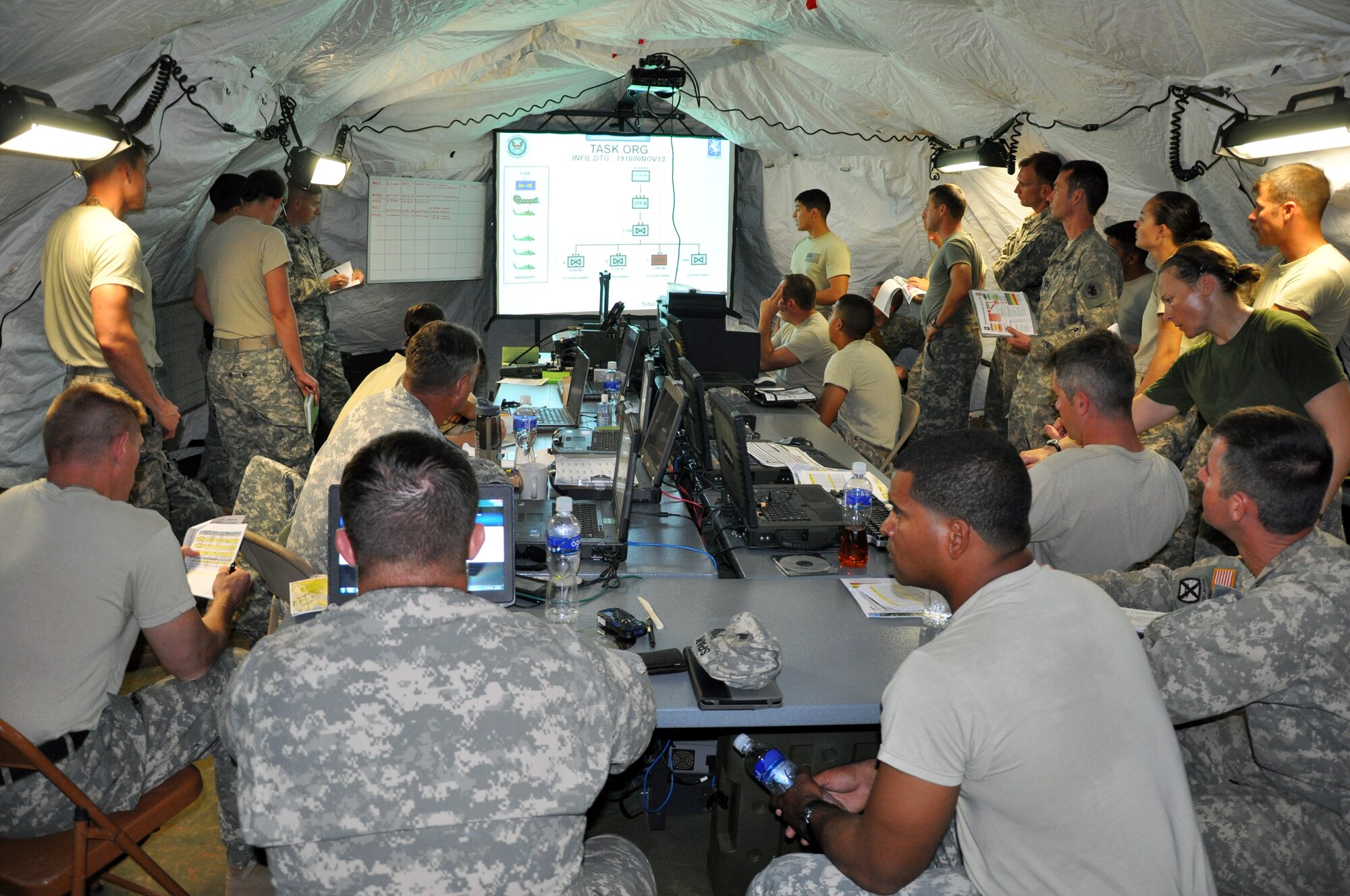 Members of the 1-228th Aviation Regiment work in the Tactical Operations Center (TOC) in Mocoron, Honduras during a week-long Collective Training Exercise (CTE) conducted by the unit, Nov. 19, 2013.  During the exercise, the members of the 1-228th operated from a field environment and responded to both exercise and real-world mission requirements.  (U.S. Air Force photo by Capt. Zach Anderson)