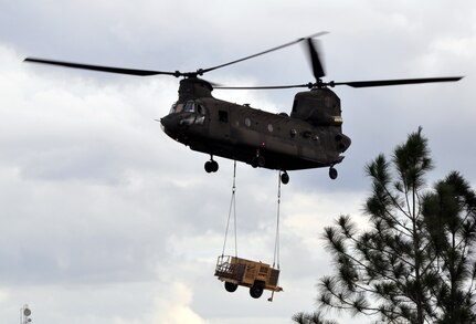 A CH-47 Chinook helicopter assigned to the 1-228th Aviation Regiment approaches Mocoron, Honduras while carrying a sling-loaded generator in order to set up a tactical operating base for a week-long Collective Training Exercise (CTE) being conducted by the 1-228th, Nov. 18, 2013.  The generator was used to provide power for the tent the members of the unit slept in during the exercise.  (U.S. Air Force photo by Capt. Zach Anderson)