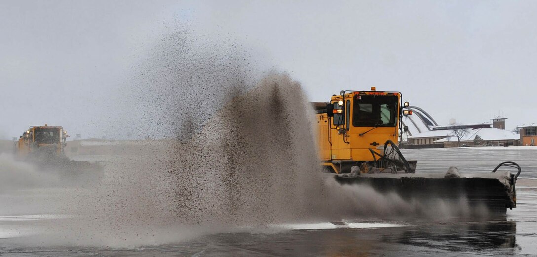 Members of the 28th Civil Engineer Squadron clear snow off the flightline and air craft parking area at Ellsworth Air Force Base, S.D. Nov. 5, 2013. Airmen of the 28th CES utilize snowplows and other heavy equipment to keep base roads, parking lots and the flightline clear of ice, snow and debris. (U.S. Air Force photo by Airman 1st Class Rebecca Imwalle/Released)