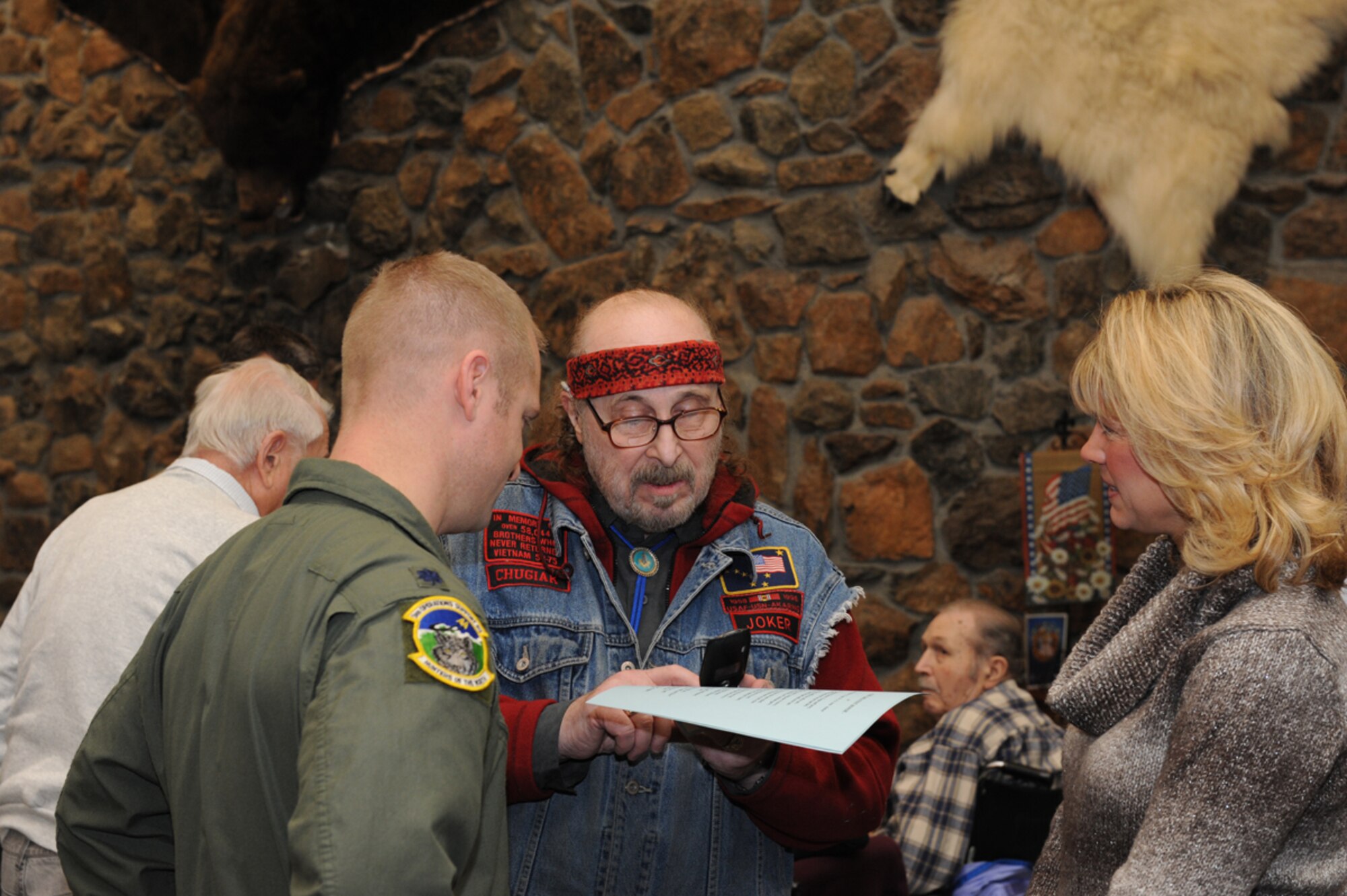 Air Force Lt. Col Brian Laidlaw, 3rd Operations Support Squadron commander, speaks with Bob Lupo, a veteran, about the poem he recited at the Alaska Veterans and Pioneers' Home, Nov. 11, 2013. Members of the Joint Base Elmendorf-Richardson 3rd Operations Support Squadron drove an hour way to visit veterans on Veterans Day.  (U.S. Air Force Photo/Airman 1st Class Omari Bernard)