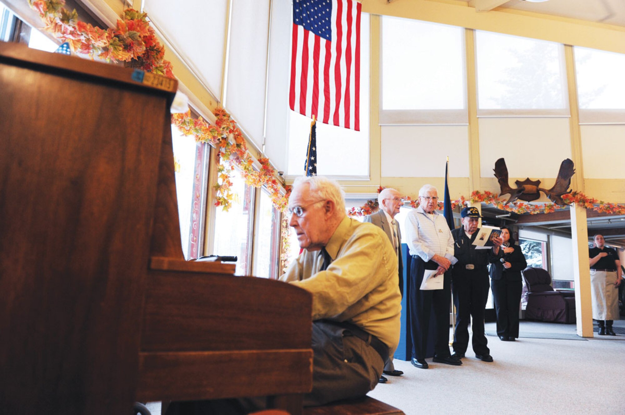 Veterans sing the Star Spangled Banner accompanied by piano at the Alaska Veterans and Pioneers' Home, Nov. 11, 2013. Members of the Joint Base Elmendorf-Richardson 3rd Operations Support Squadron drove an hour way to visit veterans on Veterans Day.  (U.S. Air Force Photo/Airman 1st Class Omari Bernard)