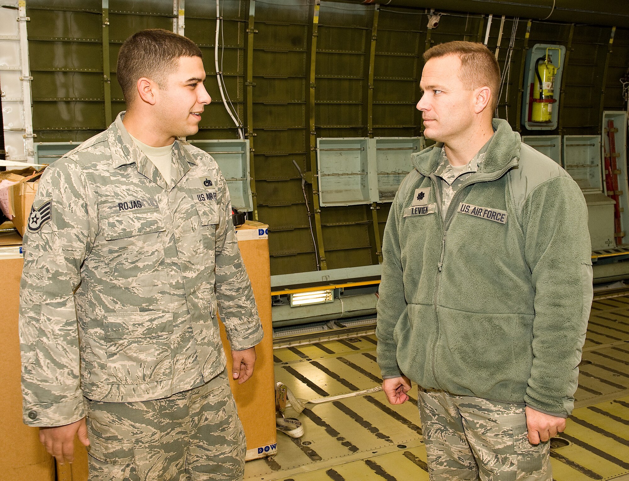 Staff Sgt. Justin Rojas, 436th Aircraft Maintenance Squadron dedicated crew chief, left, speaks with Lt. Col. Andrew Levien, right, 436th AMXS commander,in the cargo compartment of a C-5M Super Galaxy Nov. 21, 2013, at Dover Air Force Base, Del. Rojas was selected by 436 AMXS leadership, as dedicated crew chief for Team Dover's newest Super Galaxy, 85-0004. (U.S. Air Force photo/Roland Balik)