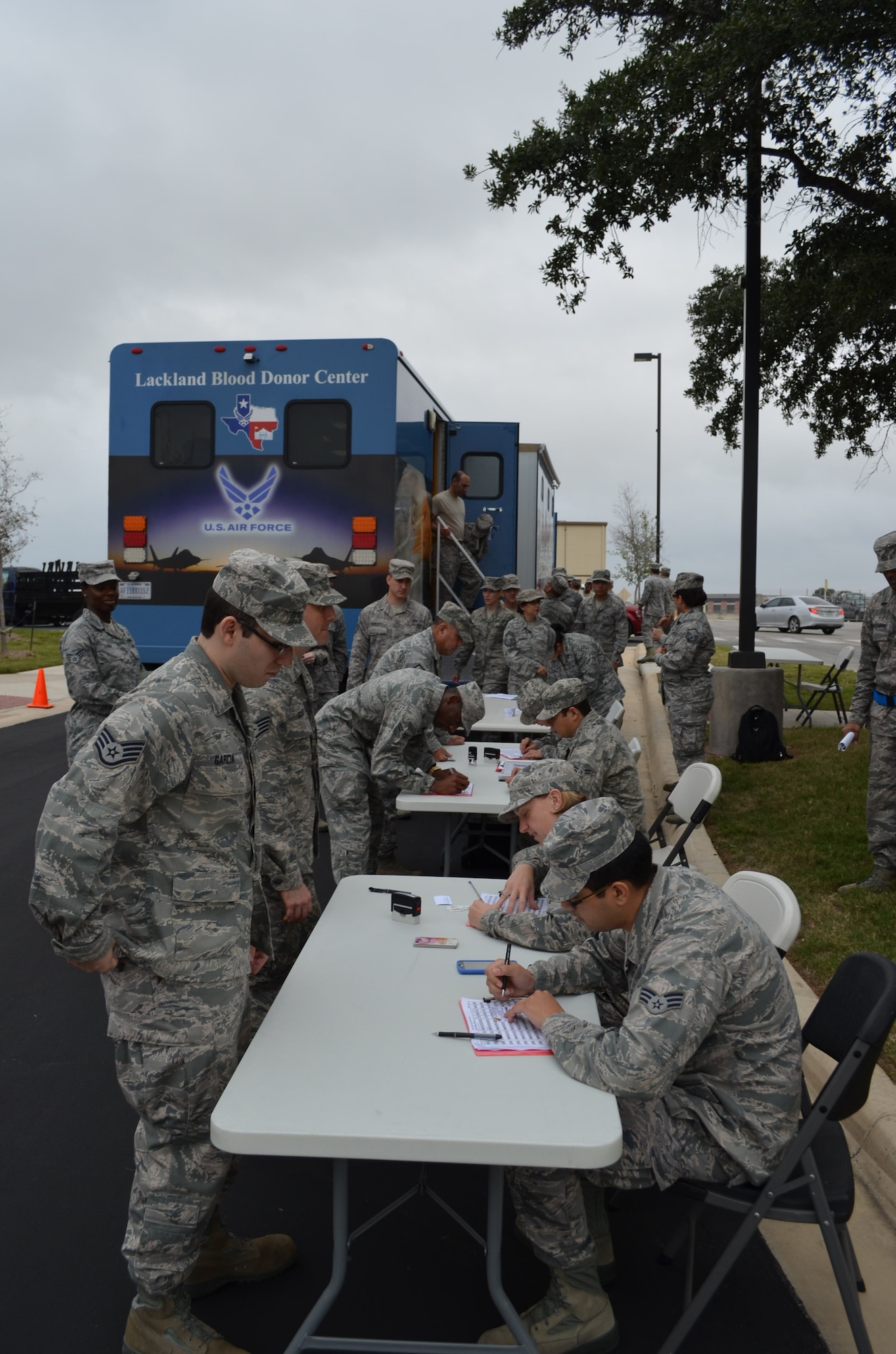 433rd Airlift Wing Airmen receive certification of their attendance after receiving their annual influenza vaccination via the Lackland Blood Donor Center mobile unit on Nov. 16, 2013. (U.S. Air Force Photo/Maj. Tim Wade)