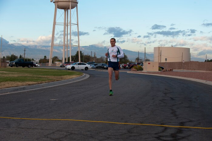 Major Aubrey Curtis, 547th Intelligence Squadron individual mobility augmentee, runs during the 5k Turkey Trot/Great American Smokeout near the Warrior Fitness Center, Nov. 21, 2013, at Nellis Air Force Base, Nev. This year the Turkey Trot, which was put on by the Warrior Fitness Center, and the Great American Smokeout, put on by the Health and Wellness Center, were combined into one 5k event. The race was called both the Turkey Trot and the Great American Smokeout in honor of the upcoming Thanksgiving holiday and to help urge Airmen and other individuals to end their tobacco use. (U.S. Air Force photo by Airman 1st Class Thomas Spangler) 