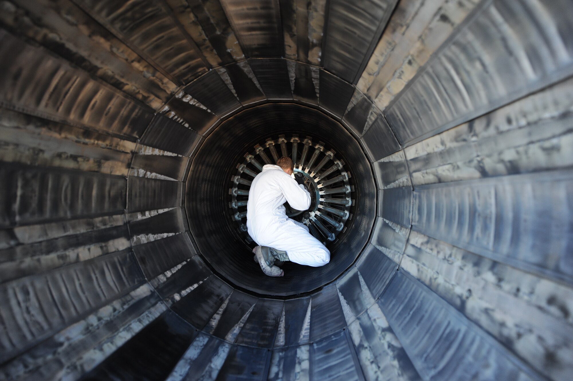 U.S. Air Force Staff Sgt. Ryan Blanton, 7th Aircraft Maintenance Squadron, thoroughly inspects turbine blades inside a B-1 engine Nov. 17, 2013, at Dyess Air Force Base, Texas. The white coveralls worn while inspecting the engine keep maintainers from dropping tools or parts in the inlets or exhaust.  (U.S. Air Force photo by Airman 1st Class Alexander Guerrero/Released)