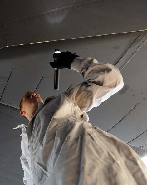 U.S. Air Force Staff Sgt. Ryan Blanton, 7th Aircraft Maintenance Squadron, inspects the inlet of a F101-102 engine on a B-1B Lancer for possible damage Nov. 17, 2013, at Dyess Air Force Base, Texas. Blanton is a jet engine specialist that is responsible for inspecting, diagnosing, and repairing engines. (U.S. Air Force photo by Airman 1st Class Alexander Guerrero/Released)