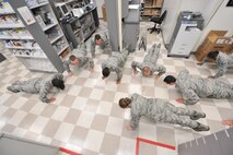 The 42nd Medical Group’s pharmacy flight begins a pushup session on Maxwell Air Force Base, Nov. 6. Currently, 90 percent of the Airmen have a score of ‘excellent’ on their standing physical training assessment, and 30 percent of those have a perfect score of ‘100.’ (U.S. Air Force photo by Staff Sgt. Natasha Stannard)