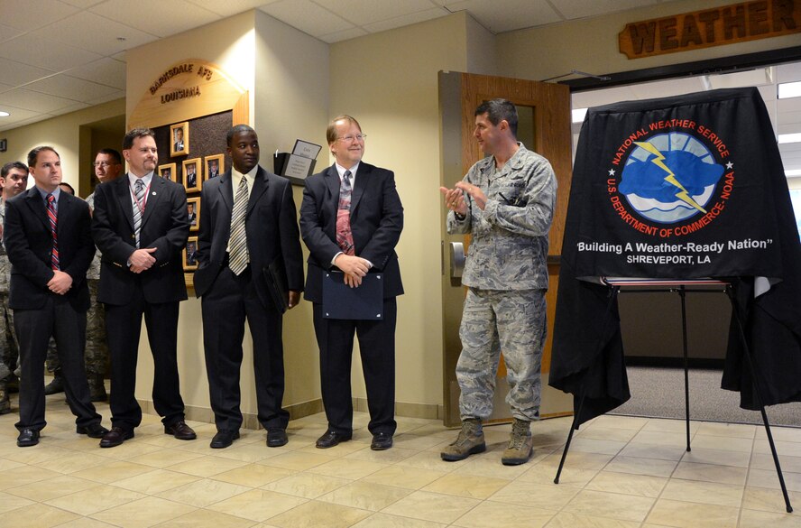 Col. Andrew Gebara, 2nd Bomb Wing commander, right, welcomes representatives from the local National Weather Service office during a ceremony on Barksdale Air Force Base, La., Nov. 15, 2013. Barksdale was recognized as a StormReady® Community and received a sign to display as commemoration of the achievement. (U.S. Air Force photo/Staff Sgt. Amber Corcoran)