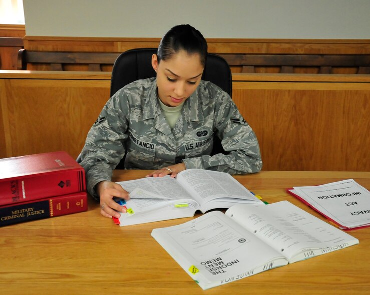 Airman 1st Class Savella Constancio, 436th Airlift Wing Jude Advocate military justice paralegal, reviews her law books to prepare for an upcoming court martial Nov 18, 2013, at Dover Air Force Base, Del. Constancio is a discharge paralegal at Dover AFB. (U.S. Air Force photo/Airman 1st Class William Johnson)