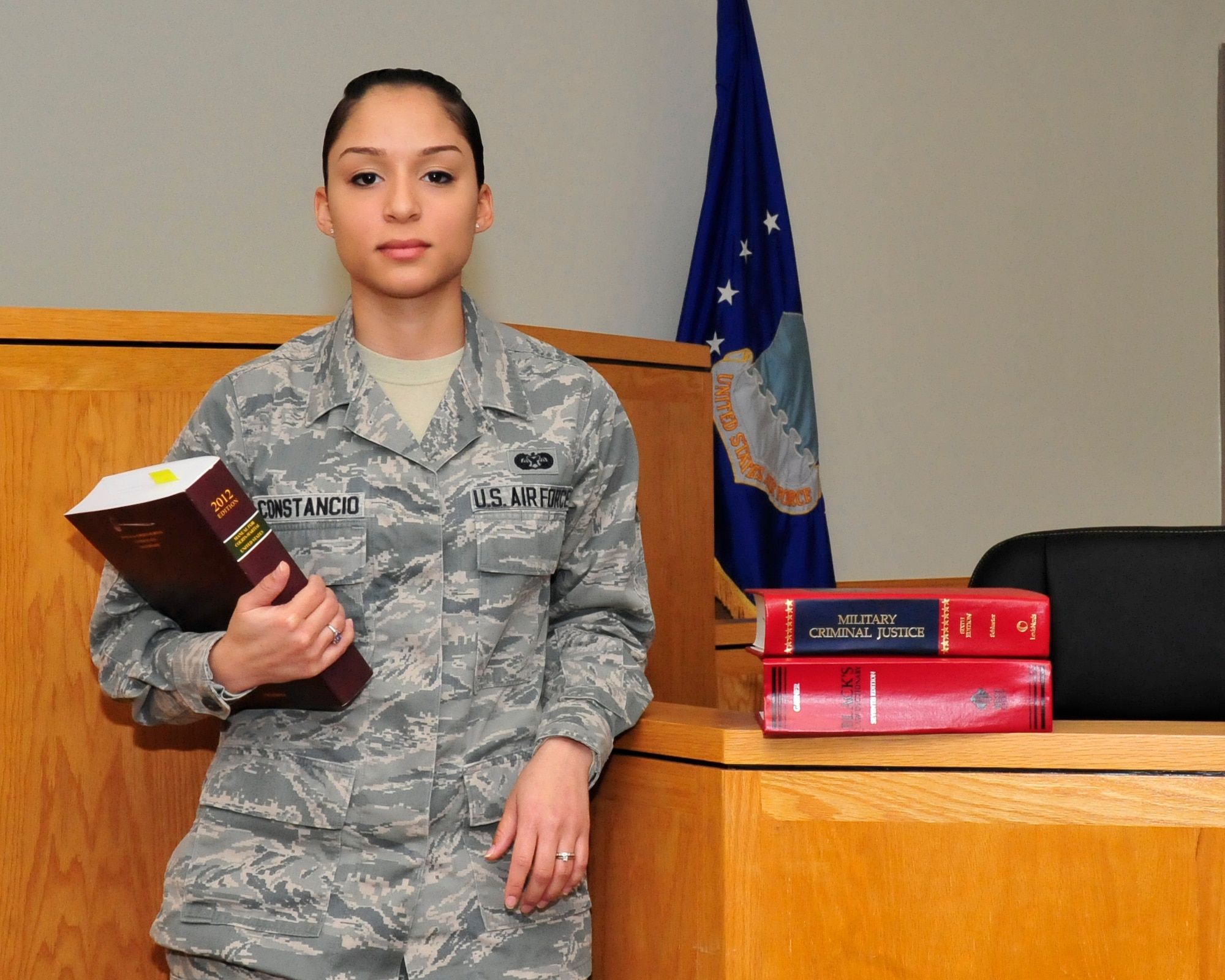 Airman 1st Class Savella Constancio, 436th Airlift Wing Jude Advocate military justice paralegal, stands in the courtroom Nov 18, 2013, at Dover Air Force Base, Del. Constancio is being recognized by her leadership as Airman of the Month. (U.S. Air Force photo/Airman 1st Class William Johnson)