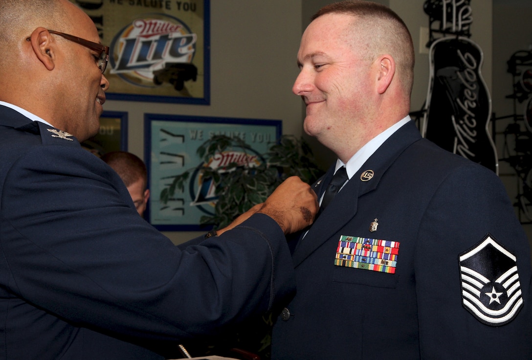 Colonel Jacob Marshall, 932nd Airlift Wing Aeromedical Staging Squadron commander, presents newly retired Master Sgt. Todd Hunt with the Air Force Retirement pin November 16, at the Scott Club, Scott Air Force Base, Ill.   "He was known for his work on medical readiness issues and focus on helping our young Airmen as they progressed in the ASTS," said fellow reservist Tech. Sgt. Chris Parr.  (U.S. Air Force photo by Tech. Sgt. Christopher Parr)