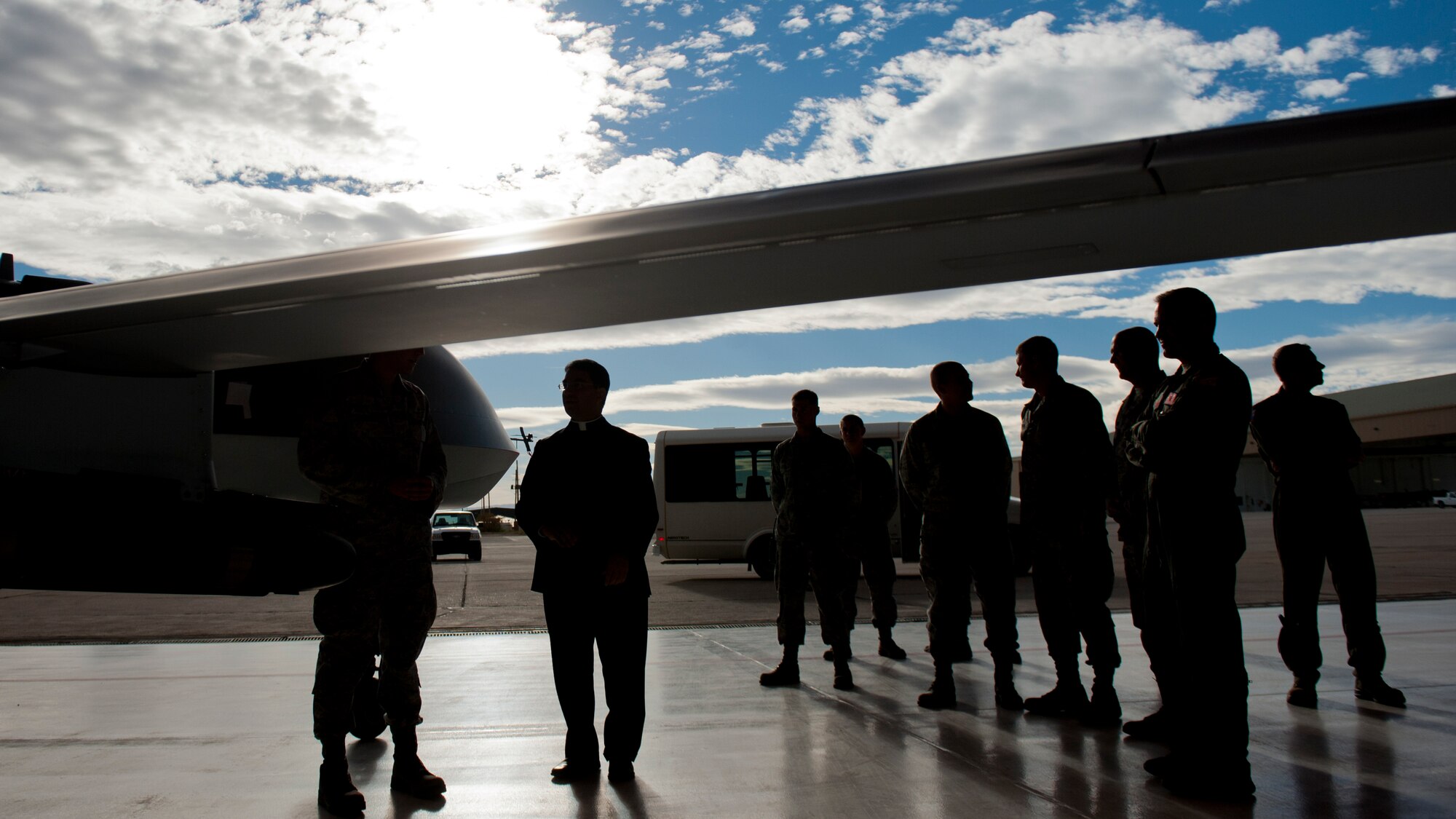 Senior Airman Timothy Snyder, 849th Aircraft Maintenance Squadron, describes the uses and abilities of the MQ-1 Predator and the MQ-9 Reaper to Bishop Oscar Cantu at Holloman Air Force Base, N.M., Nov. 20. Bishop Oscar Cantu has been appointed bishop-designate of the Roman Catholic Diocese of Las Cruces, in Las Cruces, N.M., by Pope Benedict XVI. Cantu was invited to Holloman to hold Catholic mass and to gain insight on the military lifestyle. (U.S. Air Force photo by Airman 1st Class Aaron Montoya/Released)