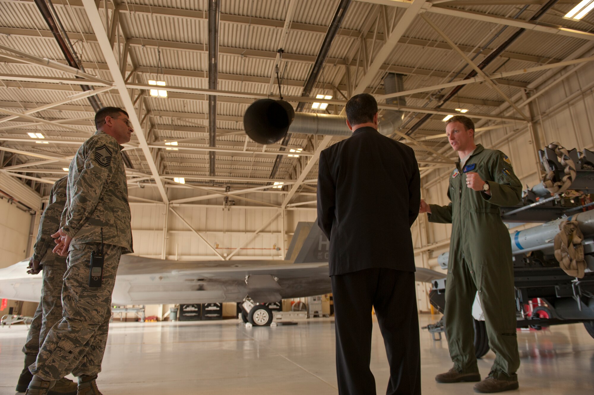 Captain Christopher Boyer, 7th Fighter Squadron F-22 Raptor pilot, describes the details and abilities of the F-22 Raptor aircraft to Bishop Oscar Cantu at Holloman Air Force, N.M., Nov. 20. Bishop Oscar Cantu has been appointed bishop-designate of the Roman Catholic Diocese of Las Cruces, in Las Cruces, N.M., by Pope Benedict XVI. Cantu was invited to Holloman to hold Catholic mass and to gain insight on the military lifestyle. (U.S. Air Force photo by Airman 1st Class Aaron Montoya/Released)