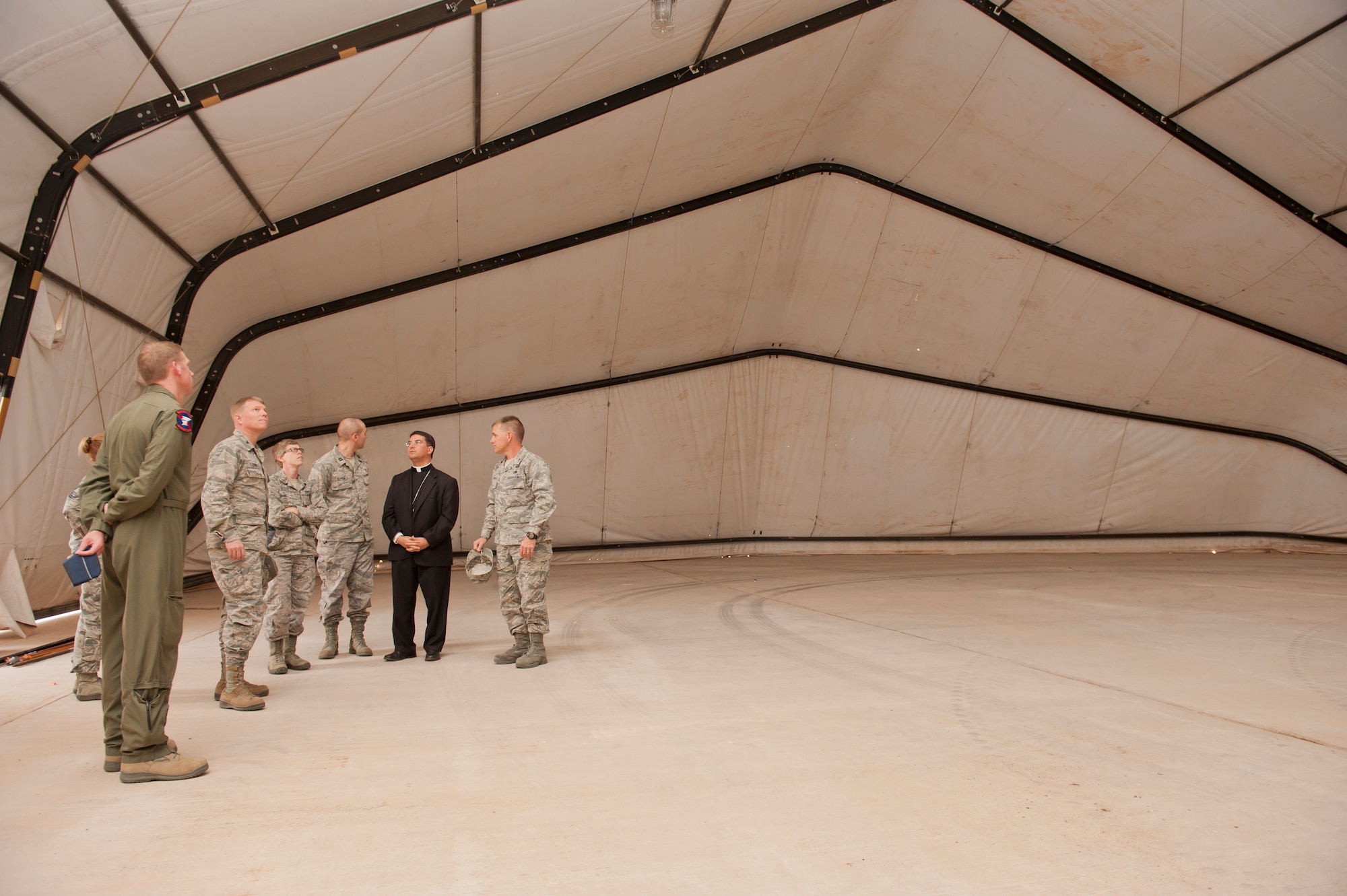 Colonel Andrew Croft, 49th Wing commander, and Col. Robert Letourneau, 49th Material Maintenance Group commander, display a 4k Dome that is used during deployments to Bishop Oscar Cantu, Roman Catholic Diocese of Las Cruces, N.M., at Holloman Air Force Base, N.M., Nov. 20. Bishop Oscar Cantu has been appointed bishop-designate of the Roman Catholic Diocese of Las Cruces, in Las Cruces, N.M., by Pope Benedict XVI. Cantu was invited to Holloman to hold Catholic mass and to gain insight on the military lifestyle. (U.S. Air Force photo by Airman 1st Class Aaron Montoya/Released)