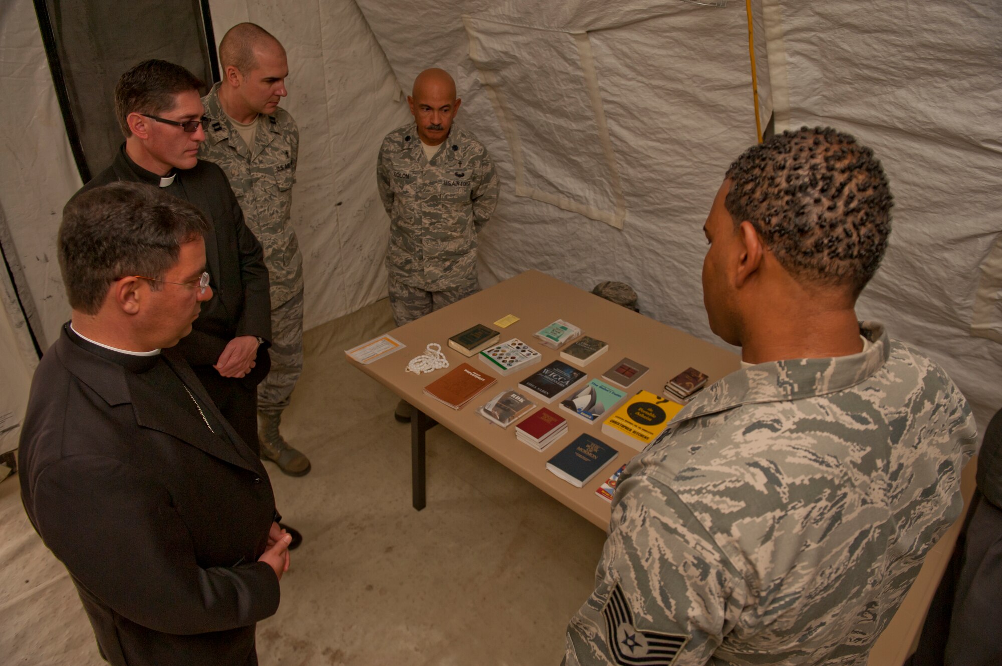Technical Sgt. Darrell Williams, Non-Commissioned Officer in Charge of Chapel Operations, displays all of the religious literature that is made available for deployed Airmen at Holloman Air Force Base, N.M., Nov. 20. Bishop Oscar Cantu has been appointed bishop-designate of the Roman Catholic Diocese of Las Cruces, in Las Cruces, N.M., by Pope Benedict XVI. Cantu was invited to Holloman to hold Catholic mass and to gain insight on the military lifestyle. (U.S. Air Force photo by Airman 1st Class Aaron Montoya/Released)