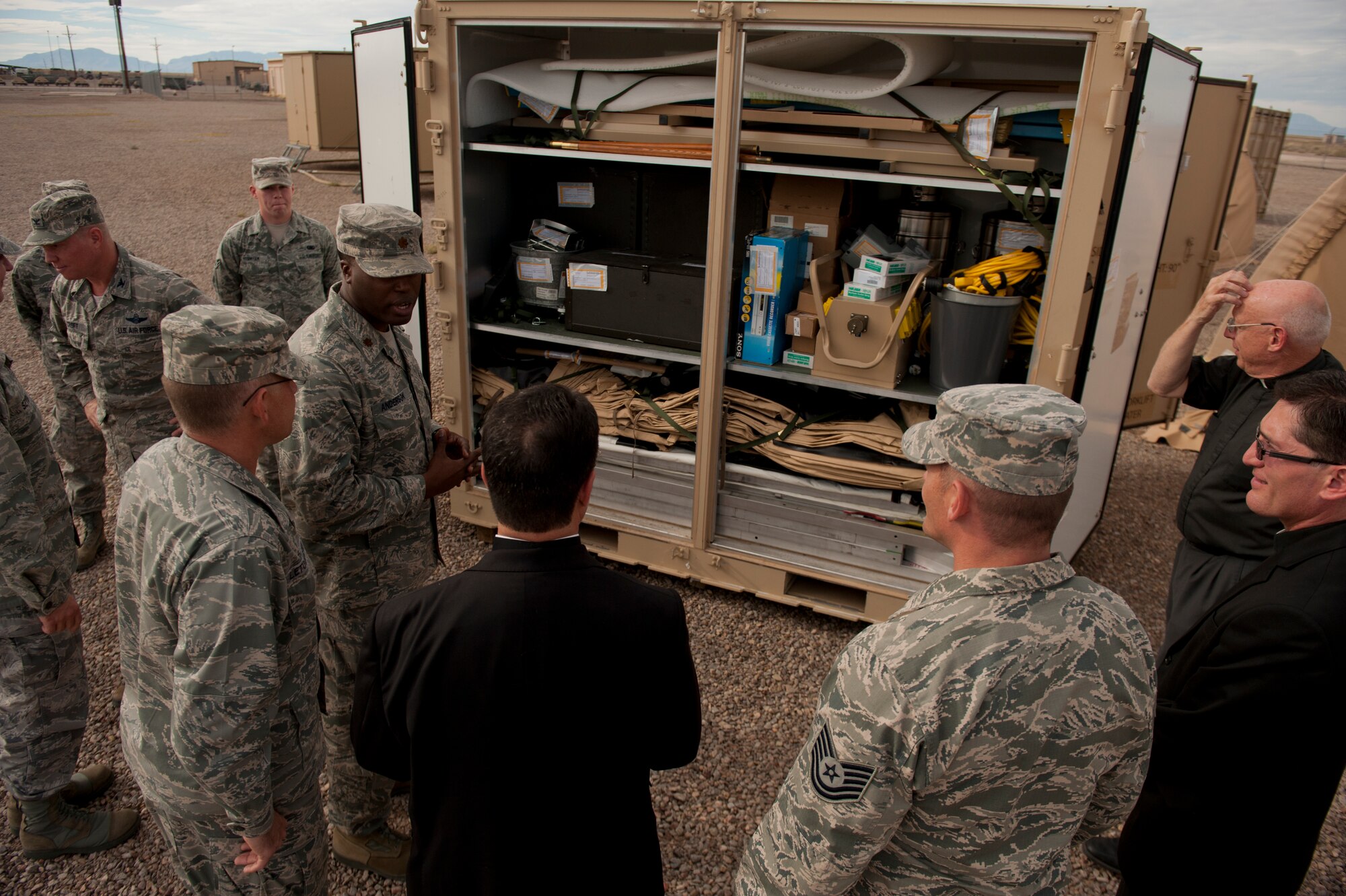 Major Clarence Anderson, 49th Materiel Maintenance Support Squadron commander, describes the Basic Expeditionary Airfield Resources process of providing deployable assets anywhere in the world at Holloman Air Force Base, N.M., Nov. 20. Bishop Oscar Cantu has been appointed bishop-designate of the Roman Catholic Diocese of Las Cruces, in Las Cruces, N.M., by Pope Benedict XVI. Cantu was invited to Holloman to hold Catholic mass and to gain insight on the military lifestyle. (U.S. Air Force photo by Airman 1st Class Aaron Montoya/Released)