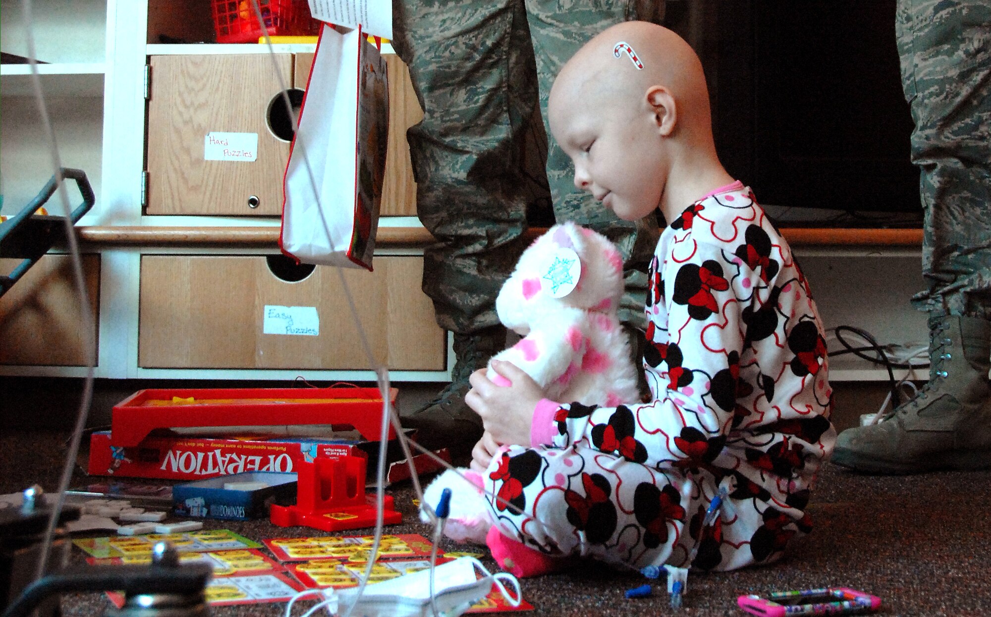 Lamya Luckey, 6, a patient at Children’s Hospital and Medical Center in Omaha, NE, takes a moment with her new Noah’s Ark Workshop bear on Nov. 20. Volunteers from the 55th Wing delivered over 90 stuffed animals on behalf of the Air Force Sergeants Association, Chapter 984. The special Noah’s Ark Workshop animals included 64 monkeys, puppy dogs, bears and cows that were assembled by Offutt members. These animals included an internal pouch where patients could place a star after making a wish. All of the animals were made available through donations to Chapter 984 of the AFSA. (U.S. Air Force photo by Delanie Stafford/Released)