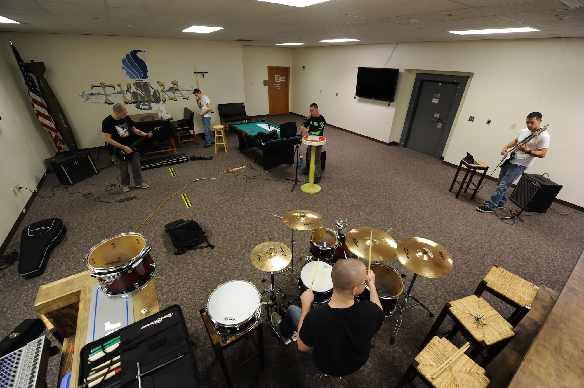 Members of the band RedBall practice a new set list in the 5th Munitions Squadron’s “Tundra” room at Minot Air Force Base, N.D., Nov. 9. RedBall’s next performance is scheduled to be at the 5th Aircraft Maintenance Squadron Christmas party this December. (U.S. Air Force photo/Senior Airman Stephanie Sauberan)