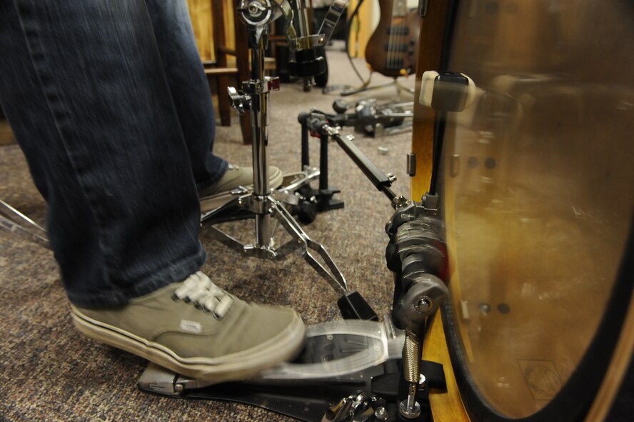 The drummer for RedBall quickly strikes his drum kit using dual peddles during band practice at Minot Air Force Base, N.D., Nov. 9. The band began as a way for its members to raise the morale of their fellow Airmen by combining their musical talents and performing at a variety of base functions. (U.S. Air Force photo/Senior Airman Stephanie Sauberan)