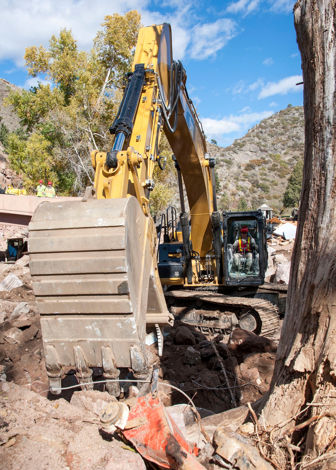 Airman 1st Class Clancy Mickelson, who is a vehcile maintanier by trade with the 219th Red Horse unit from Montana, skillfully operates an excavator in a riverbed near Colorado Route 36.  His civilian job has been working for his father in a landscaping business which has made him an expert in operating this excavator which is why he was hand picked to assist on this project. National guard units from Colorado, Utah, Kansas and Montana participate in reconstruction the Colorado State Route 36 after recent floods devistate the area.  Army and Air National Guard units provide civil engineer and Red Horse units to repair the roads and provide a 24-foot wide passable road before December 1st, 2013.  Currently they are ahead of schedule.  National Guard photo by Senior Master Sgt. John Rohrer.