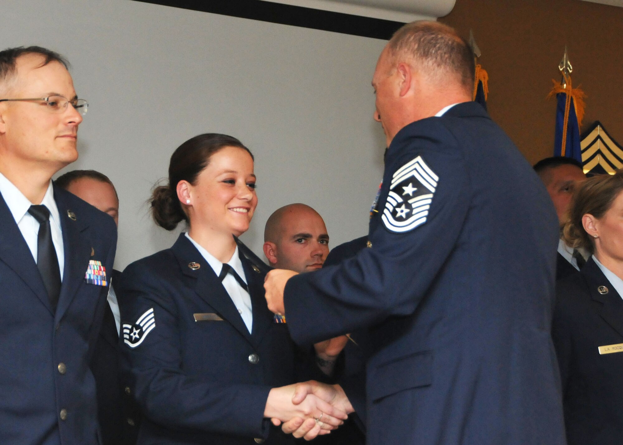 120th Command Chief Master Sgt. Timothy Huffman presents a certificate of induction to newly promoted Staff Sgt. Holly Heffley during the NCO Induction Ceremony held at the 120th Fighter Wing in Great Falls, Mont. on Nov. 4, 2013. National Guard photo/Senior Airman Nik Asmussen.